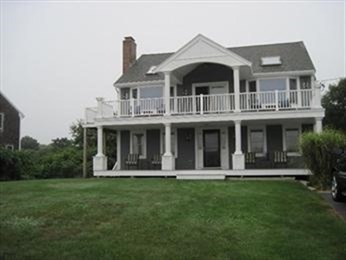 a front view of house with a garden