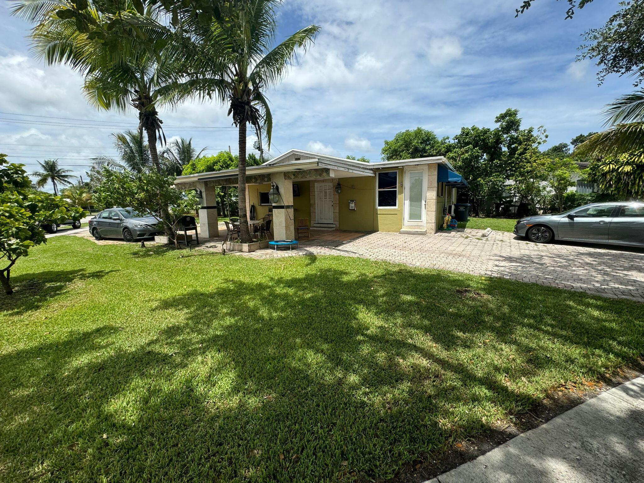 a front view of a house with yard and green space