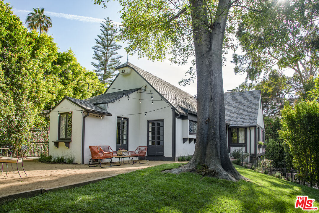 a front view of house with a garden and patio