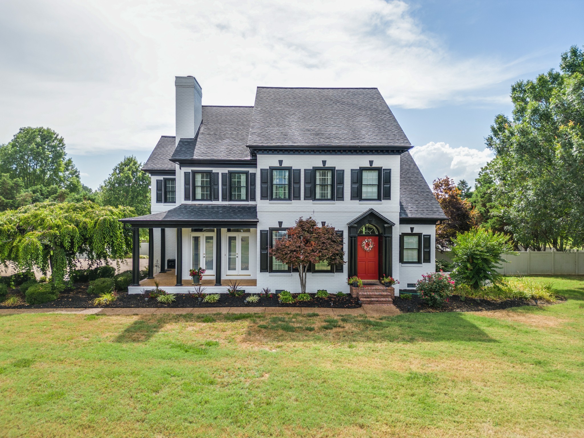 a front view of house with yard and green space