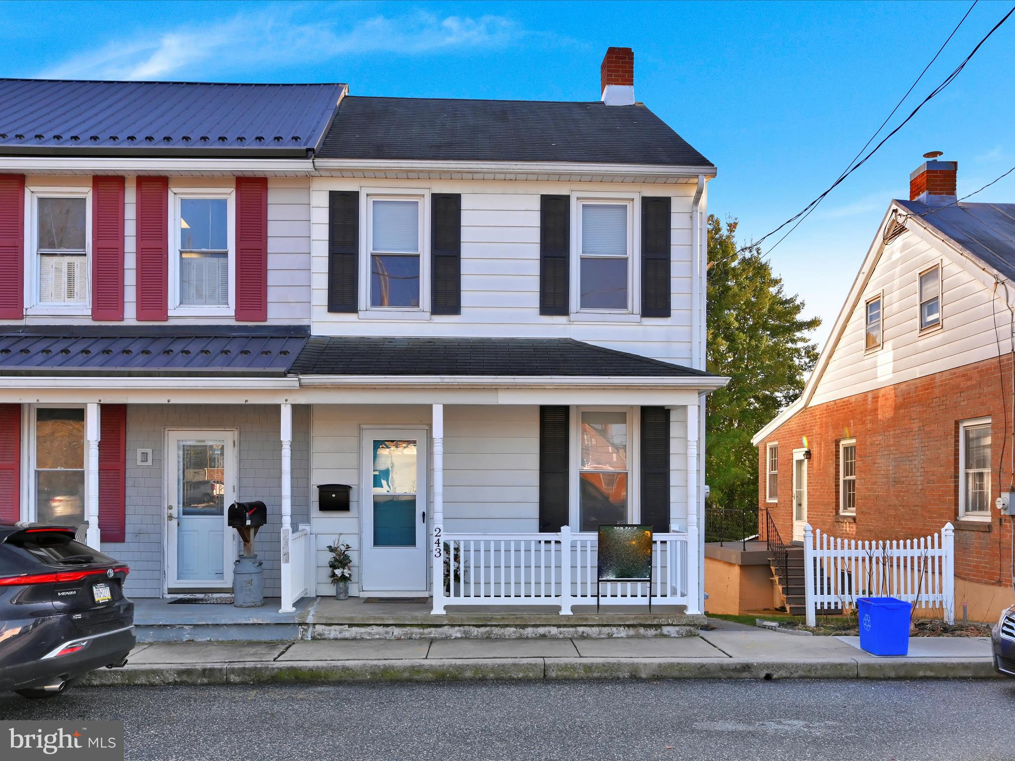 a front view of a house with a road