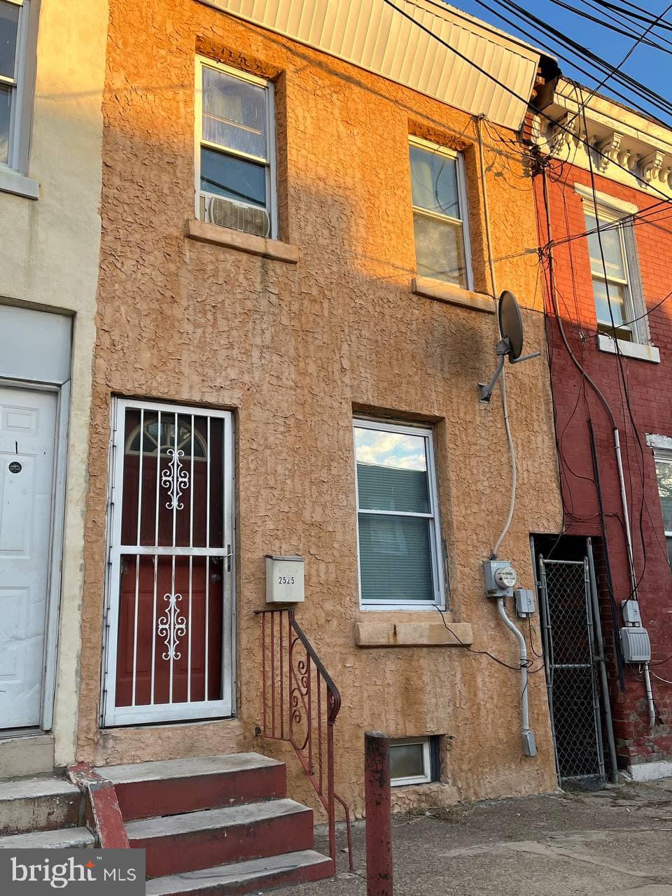 a view of a brick house with large windows