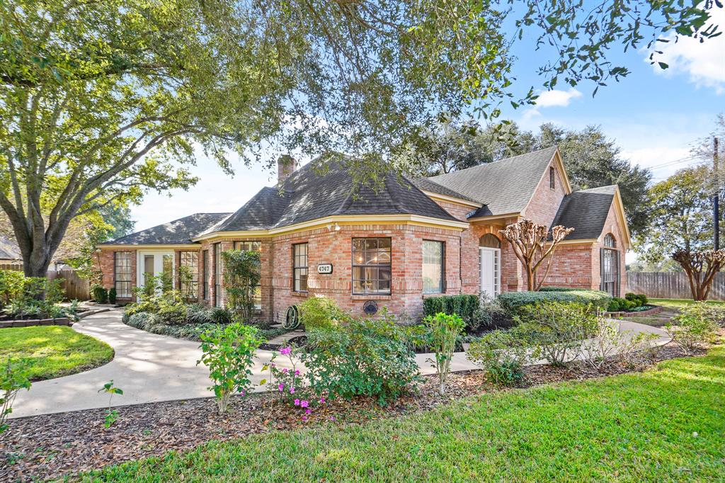 This view showcases how the home is warm and inviting from every angle! Thanks to the fact that the garage is positioned at the back of the home, it allows the front to have a park-like feel – resulting in top notch curb appeal.