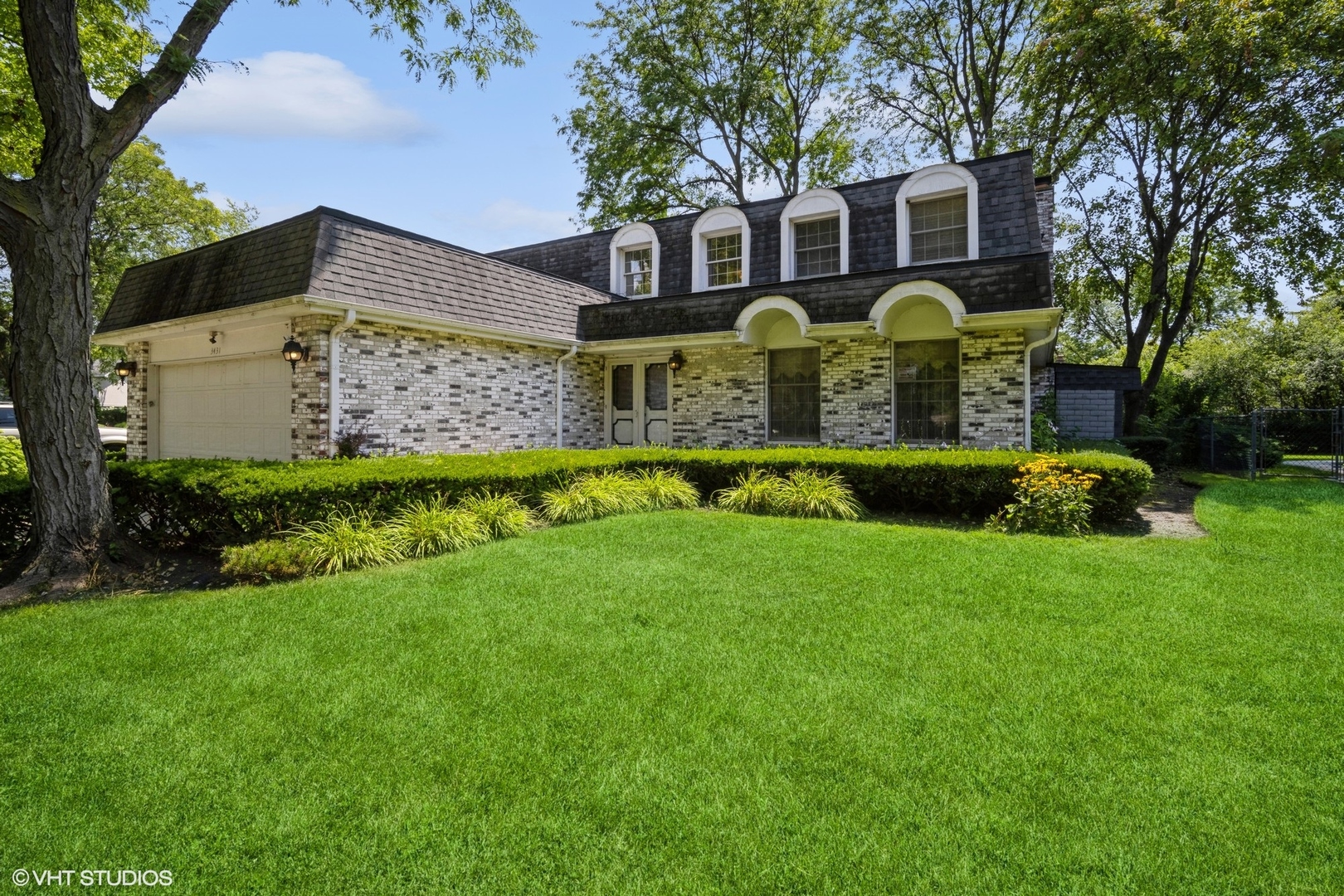 a front view of house with yard and green space