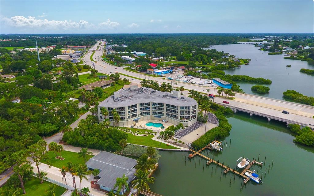 an aerial view of house with yard lake and ocean view