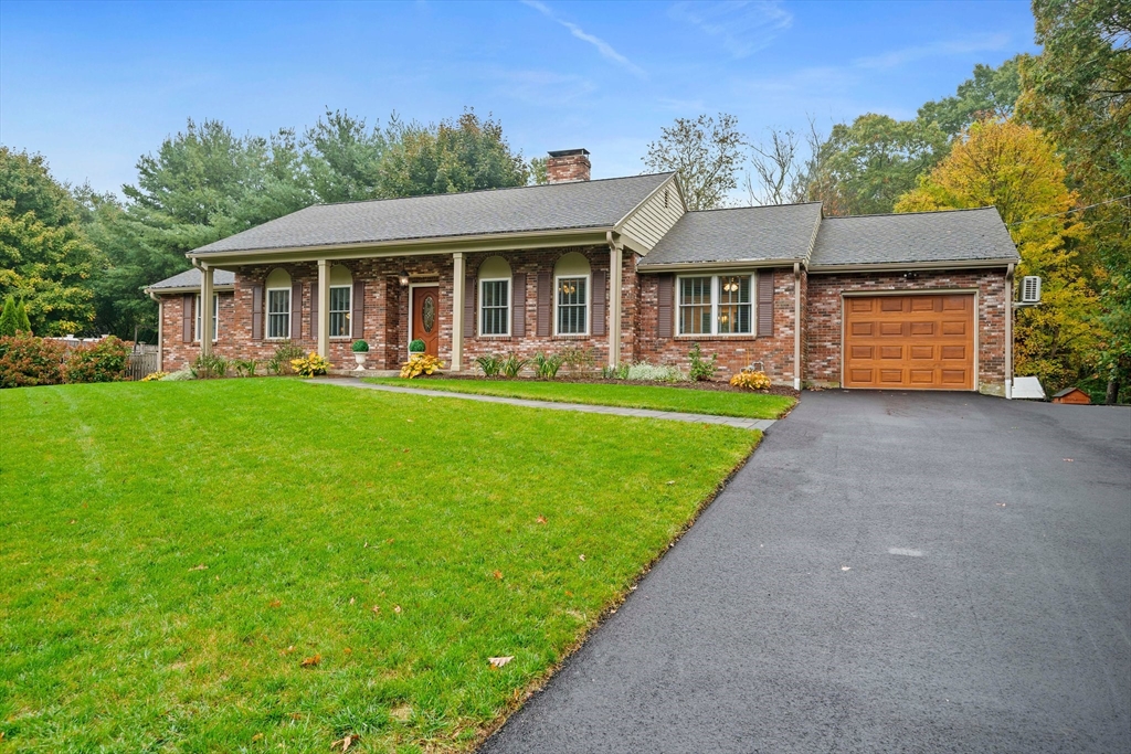 a front view of house with yard barbeque and outdoor seating