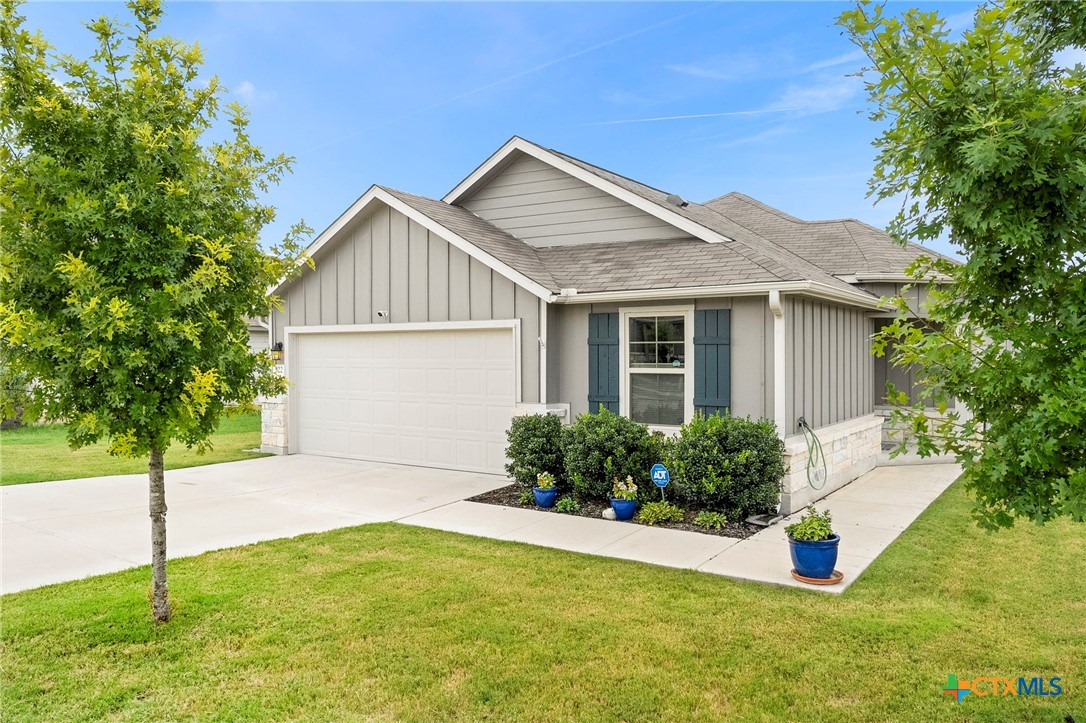 a front view of a house with a yard and garage