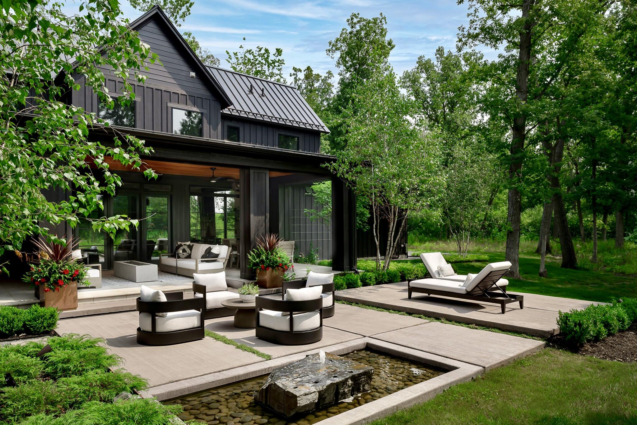 a view of a patio with couches chairs and a yard