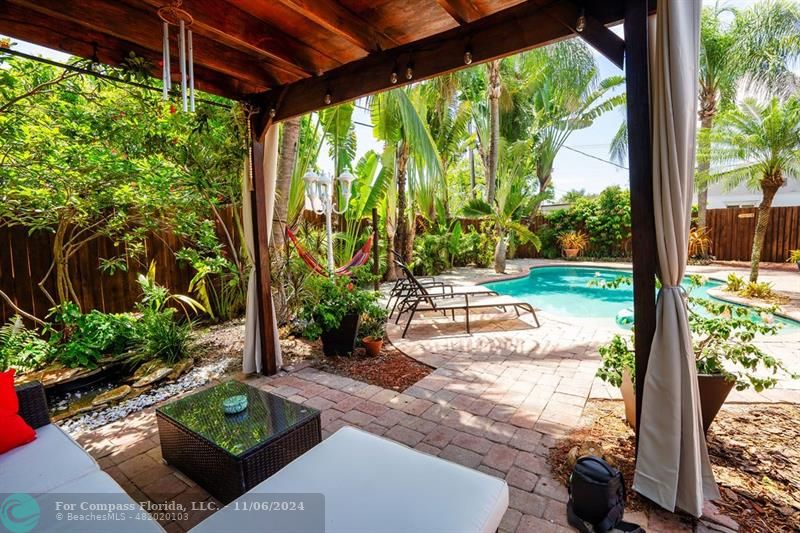 a view of backyard with plants and outdoor seating