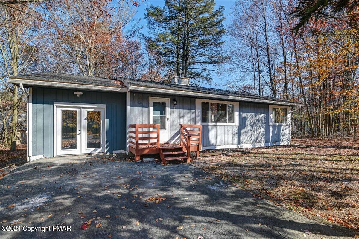 a view of a house with backyard porch and sitting area