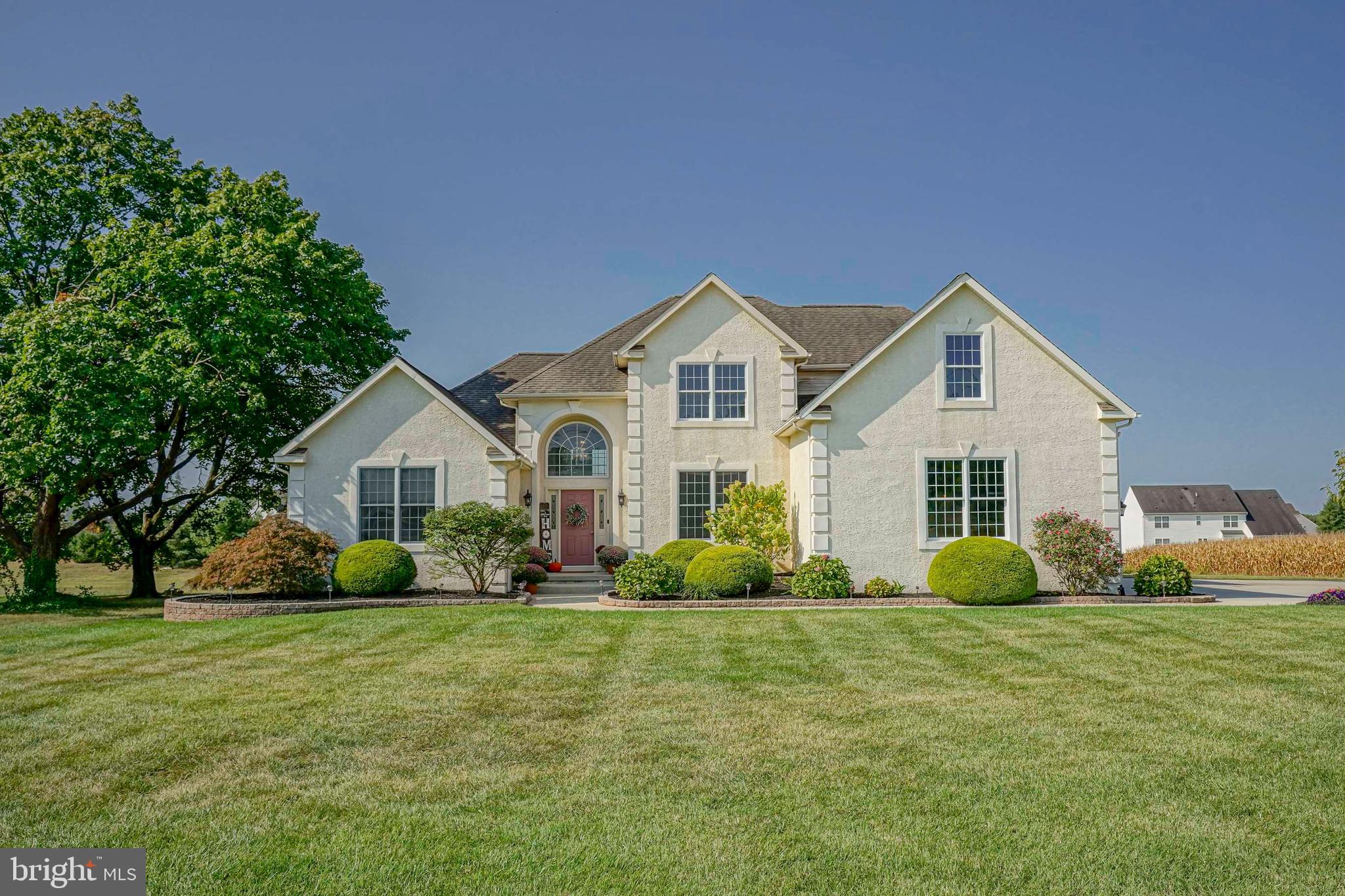 a front view of house with yard and green space