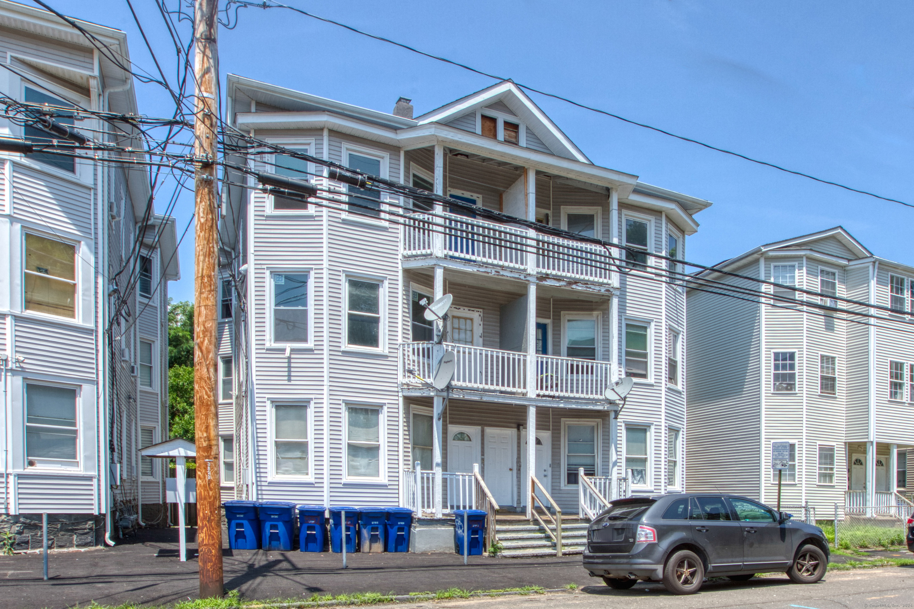 a front view of a residential apartment building with a yard