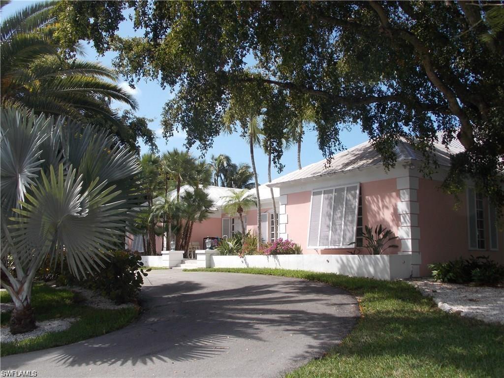 a view of a house with a tree in the yard