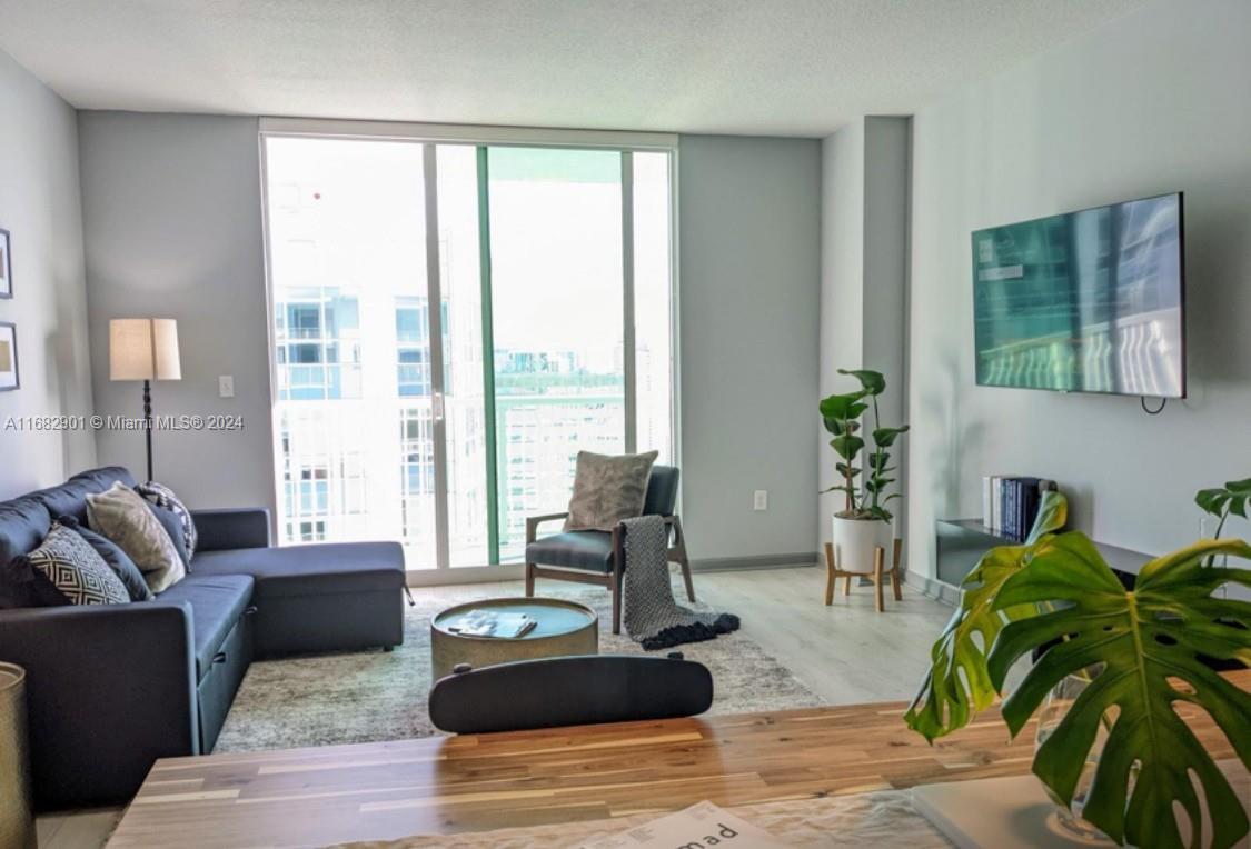 a living room with furniture and large windows