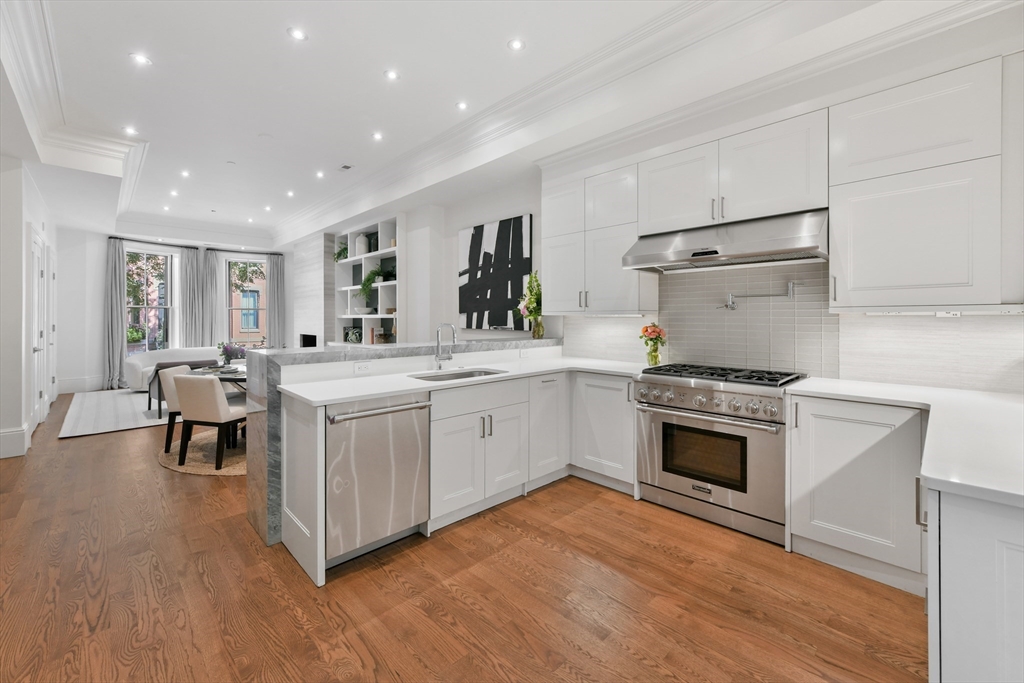 a kitchen with a sink stove and a refrigerator