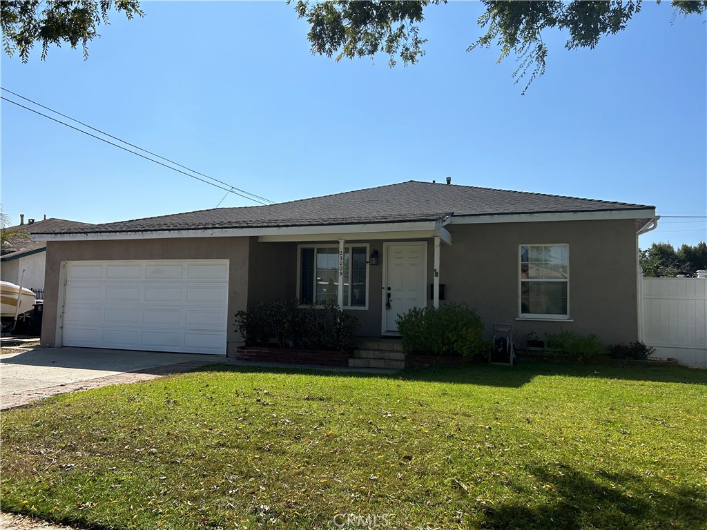 a front view of house with yard and parking space