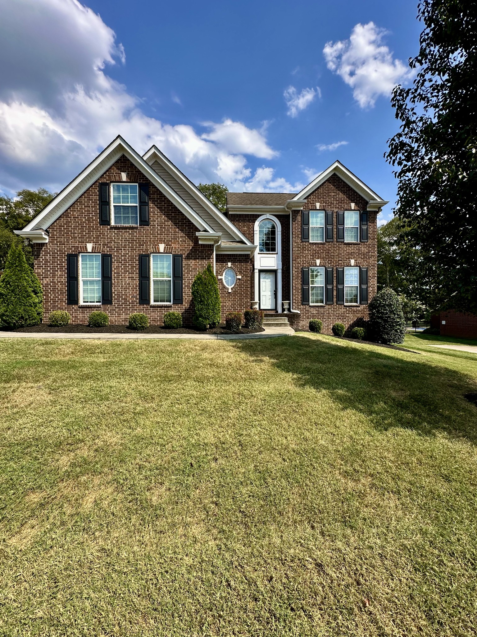 a front view of house with yard and green space