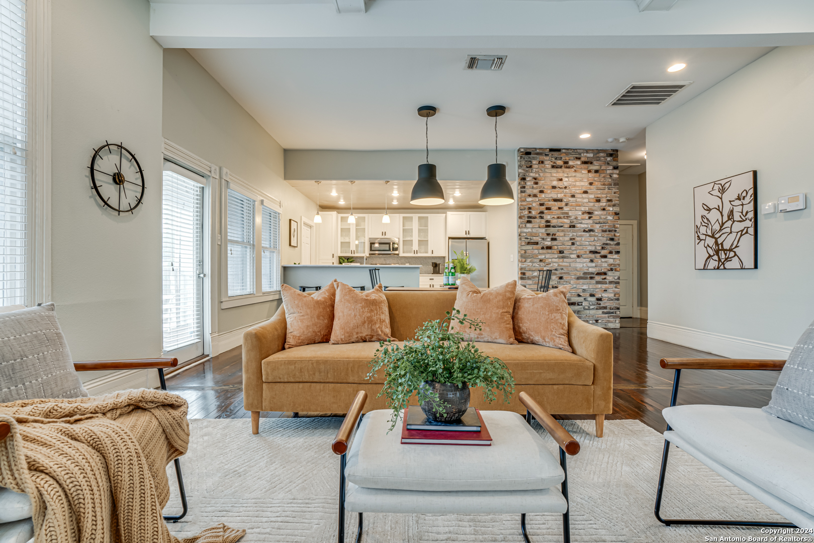 a living room with furniture a chandelier and a large window