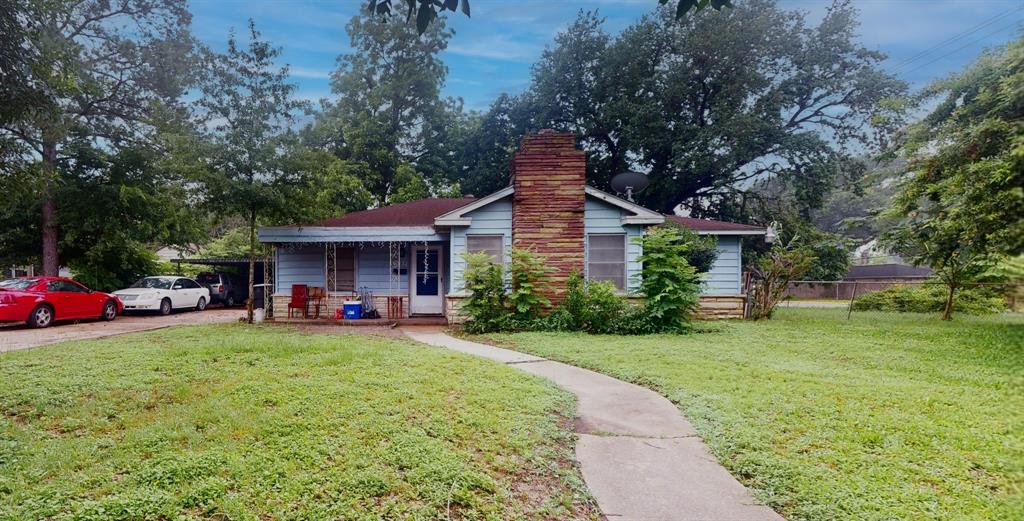 a view of a house with a yard and sitting area