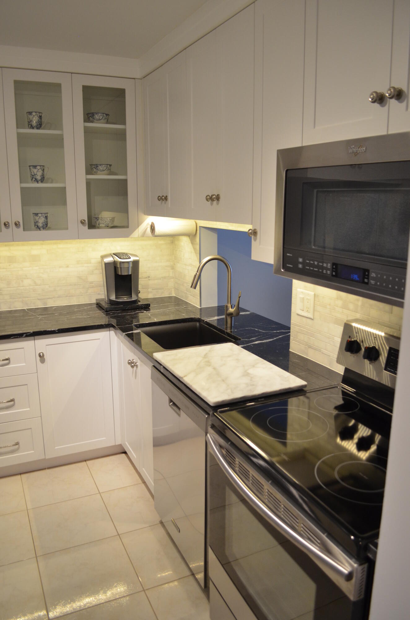 a kitchen with granite countertop a stove and a sink