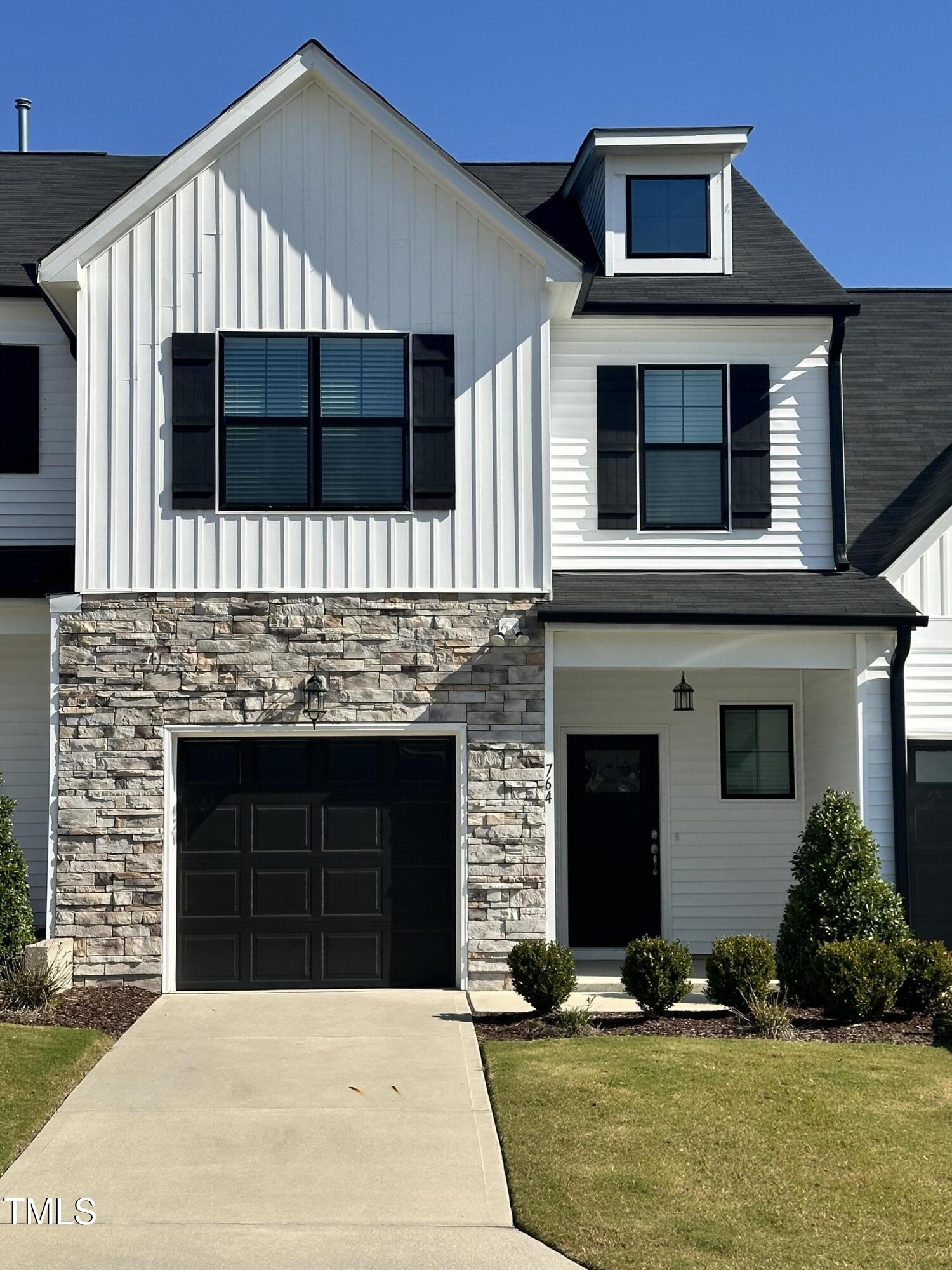 a front view of a house with garage