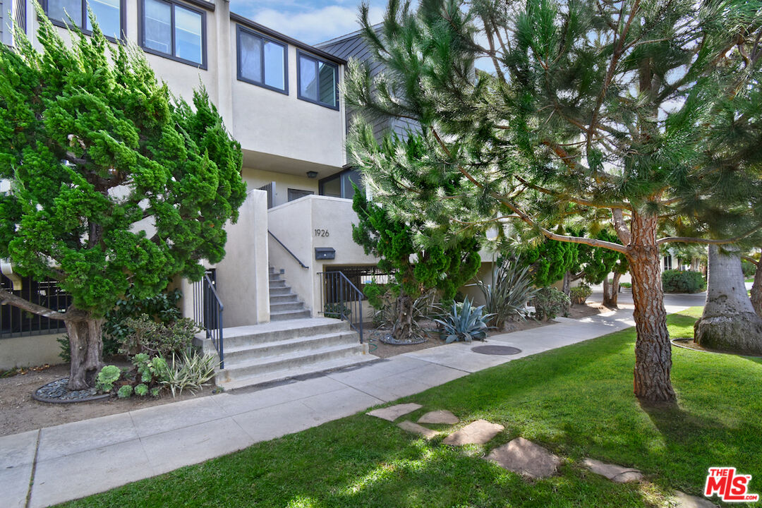 a view of a house with a yard and tree s