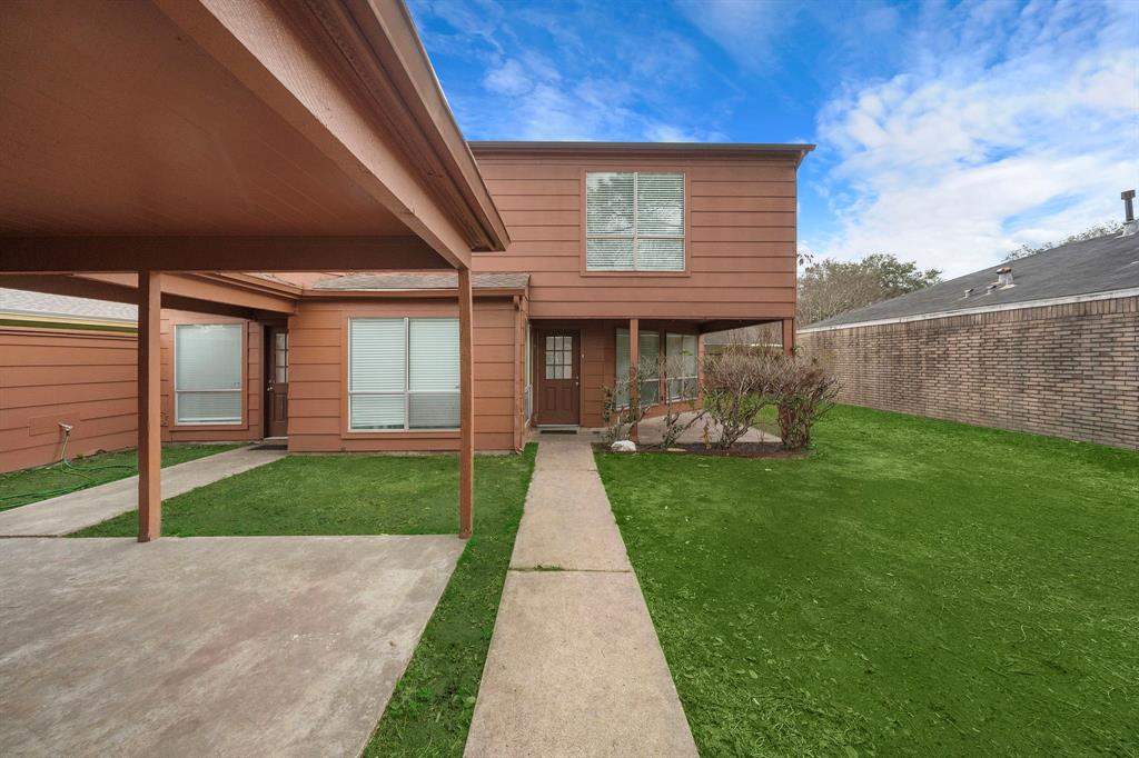 a front view of a house with a garden and yard