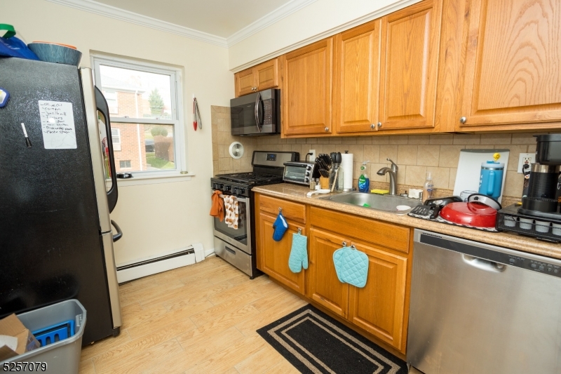 a kitchen with stainless steel appliances a stove a sink and a refrigerator