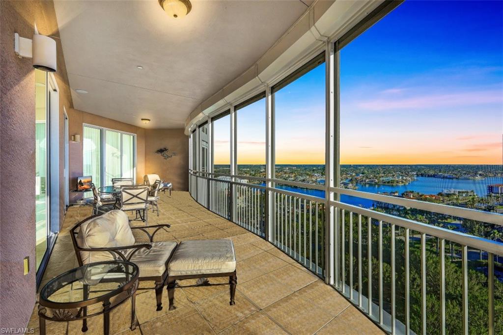 a view of a balcony with table and chairs