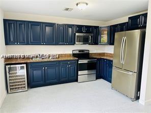 a kitchen with stainless steel appliances granite countertop a refrigerator stove a sink and dishwasher