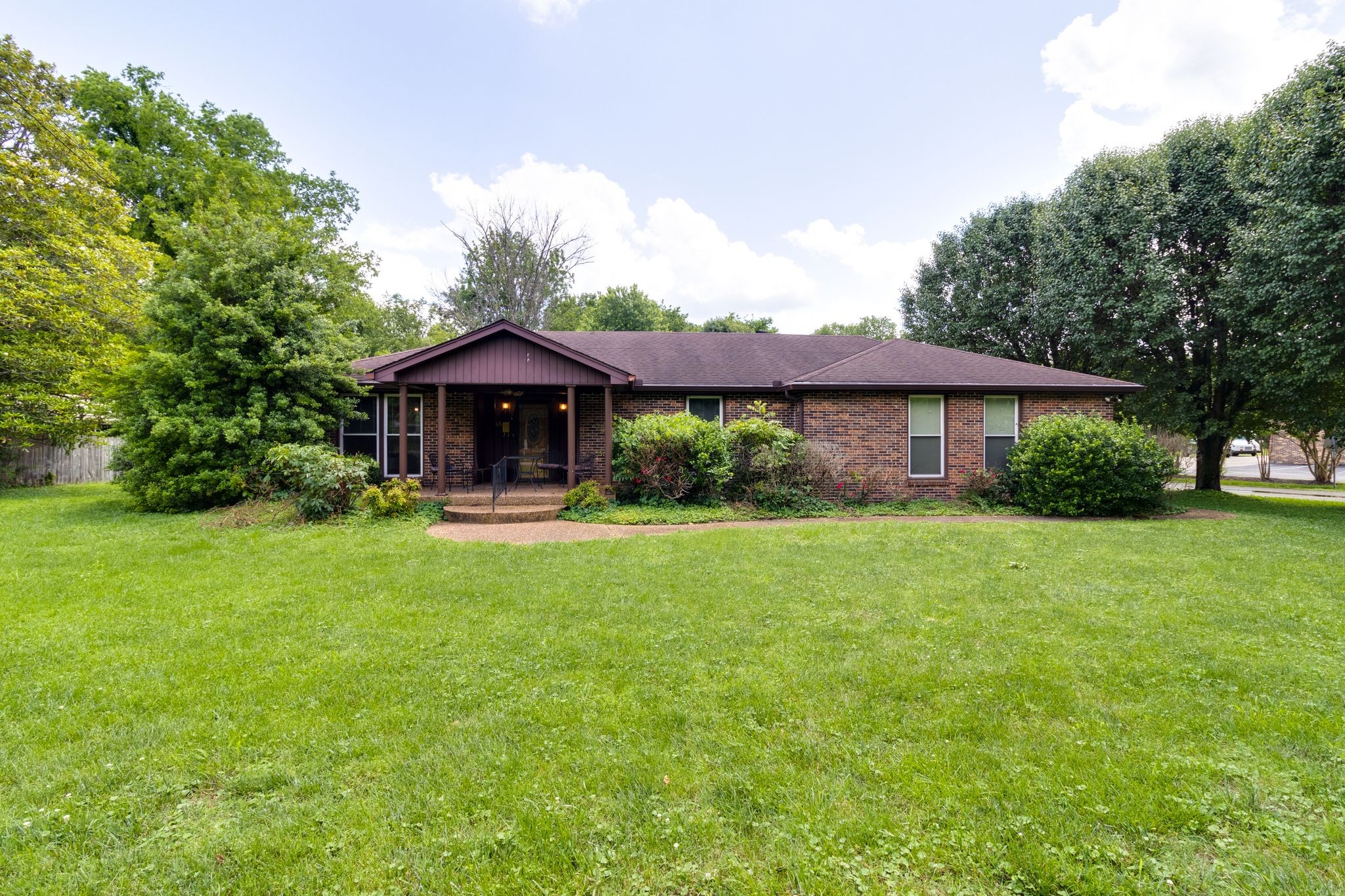 a front view of a house with a garden