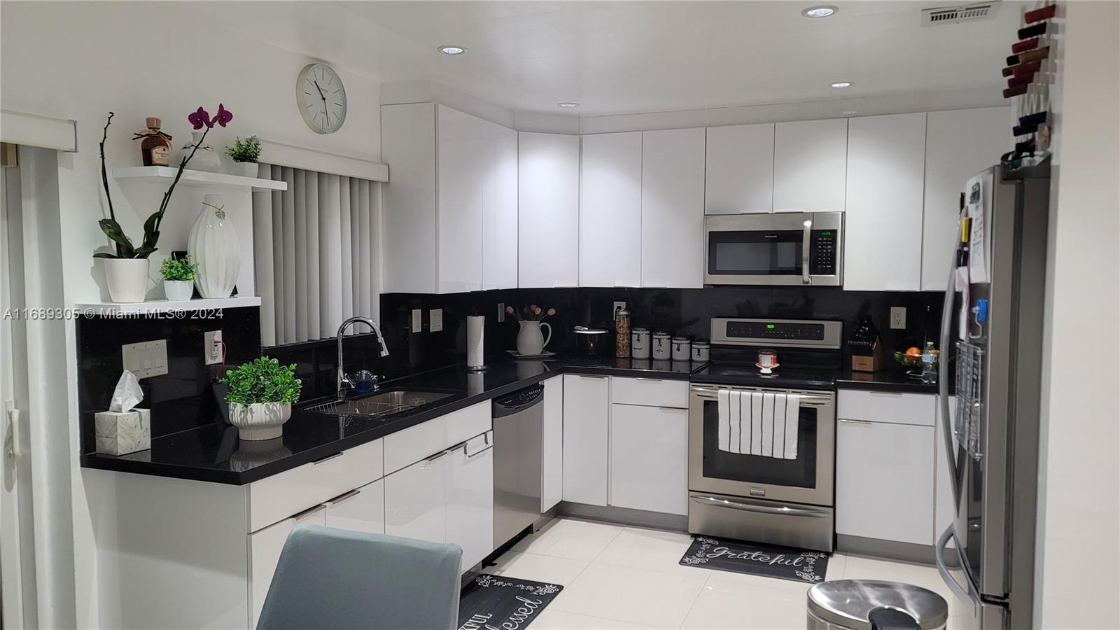 a kitchen with microwave a stove and cabinets