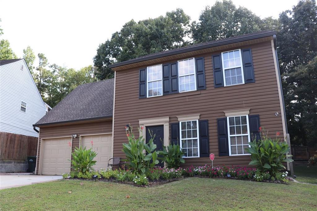 a front view of house with yard and green space