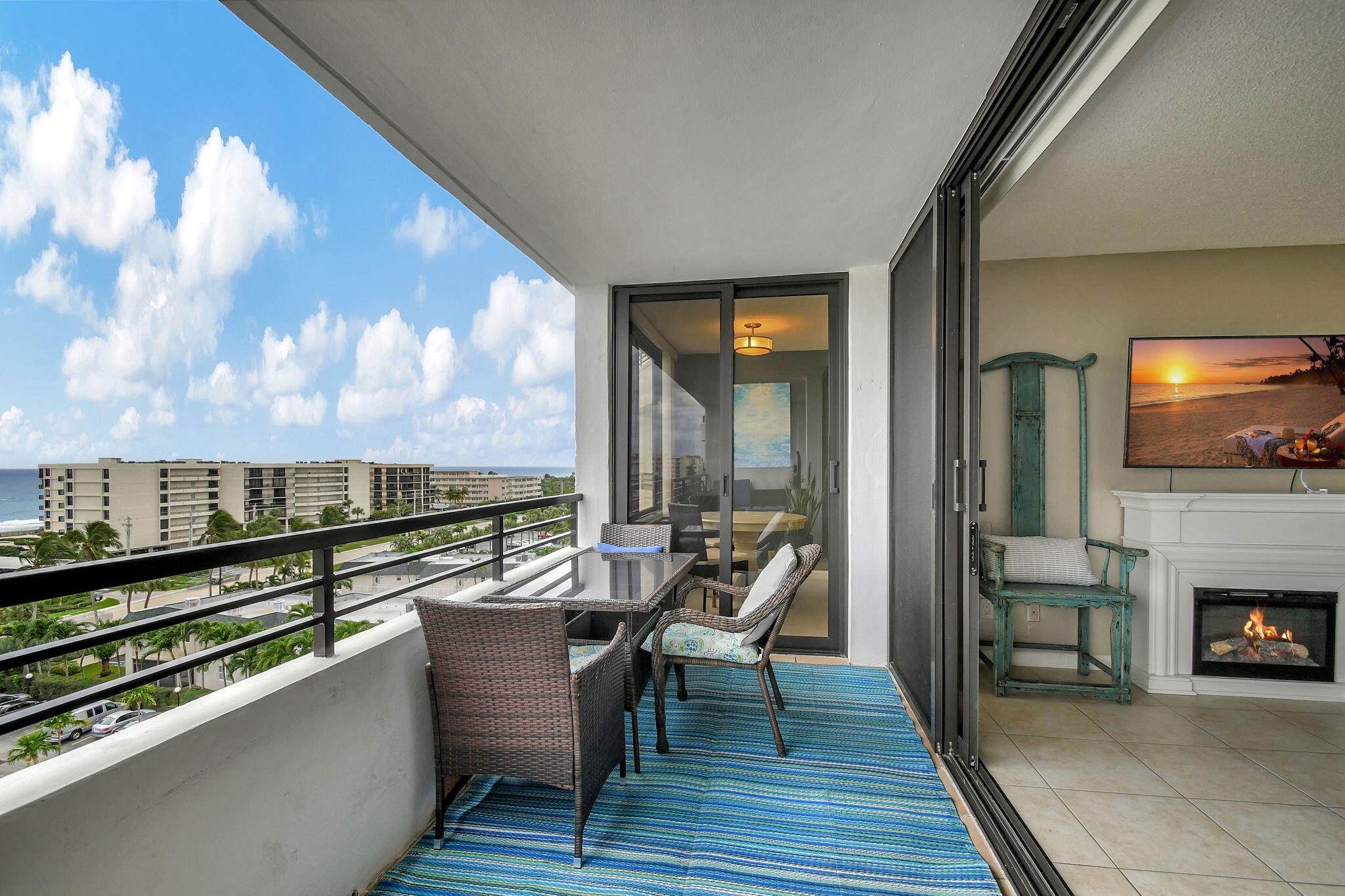 a balcony with furniture and a fireplace