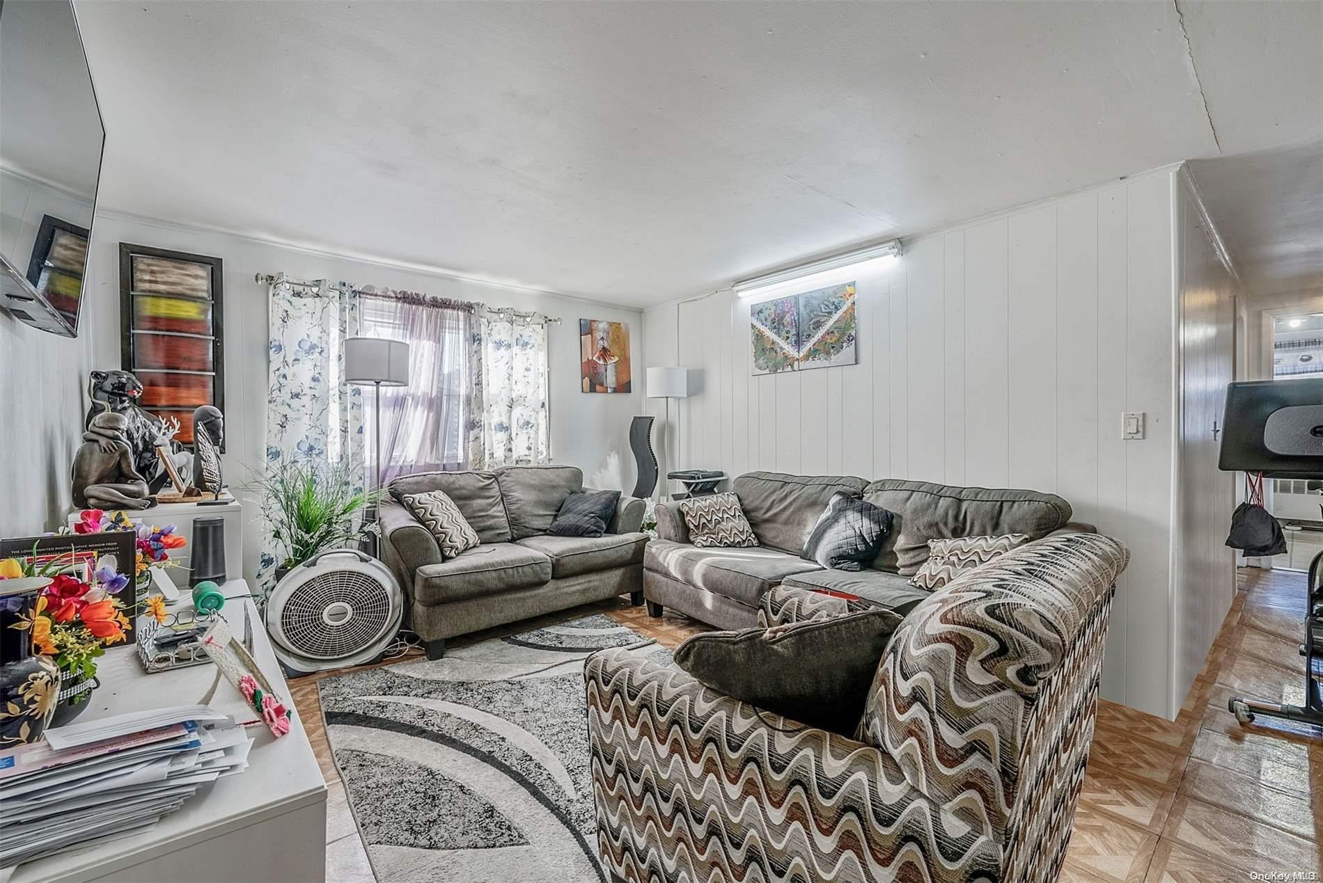 a living room with furniture a couch and a window