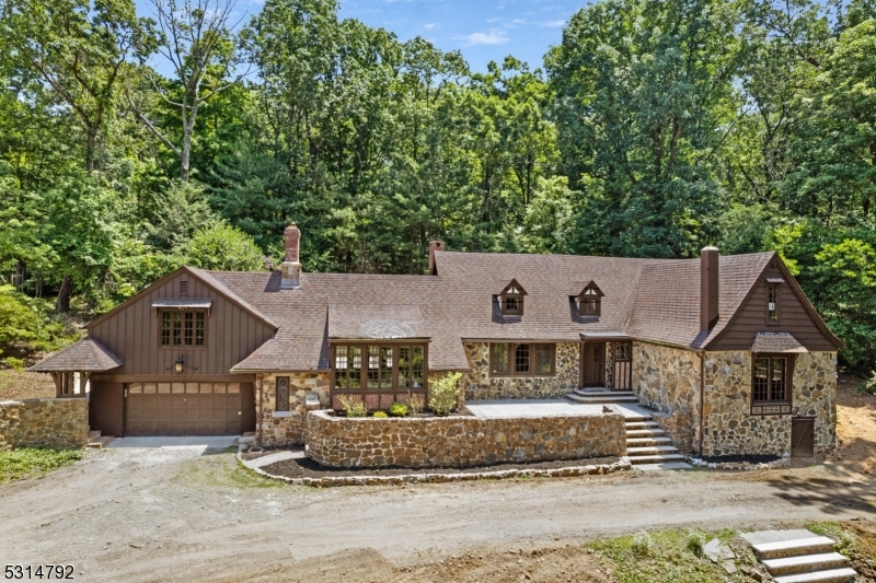 a front view of a house with a yard and tree s