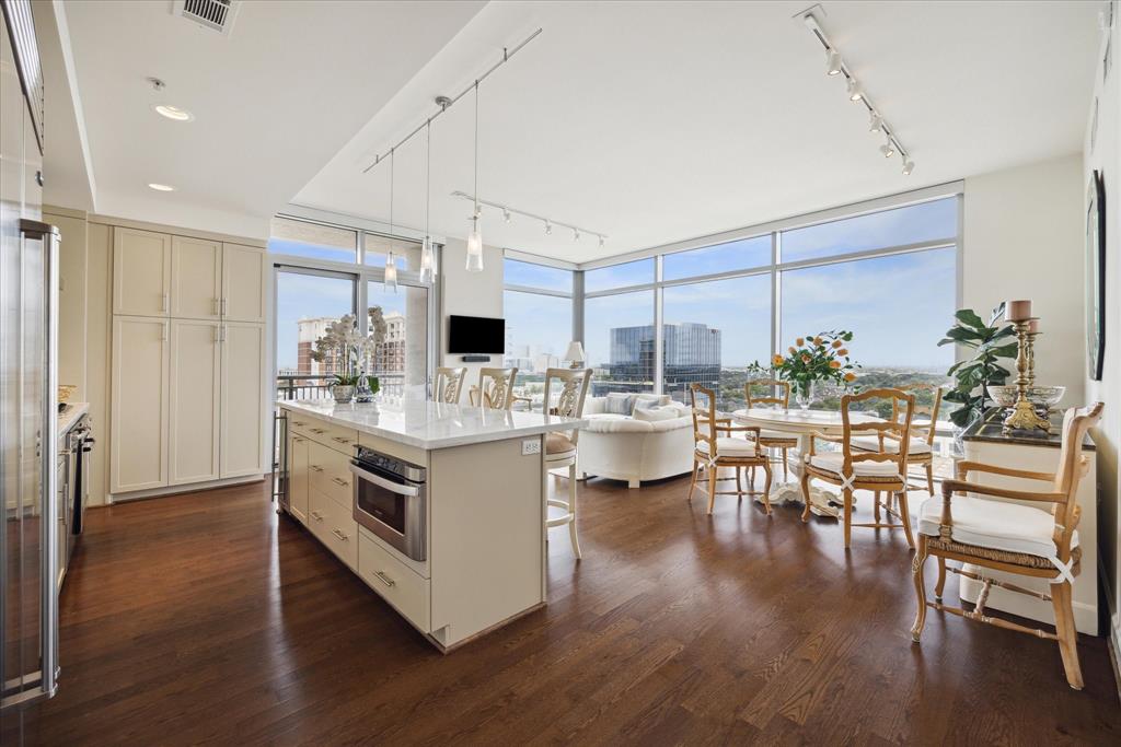 a kitchen with a sink cabinets and wooden floor