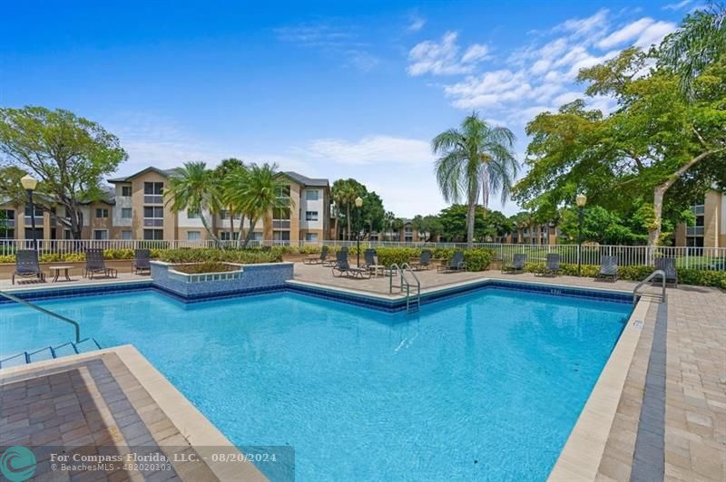 a view of a swimming pool with lounge chair