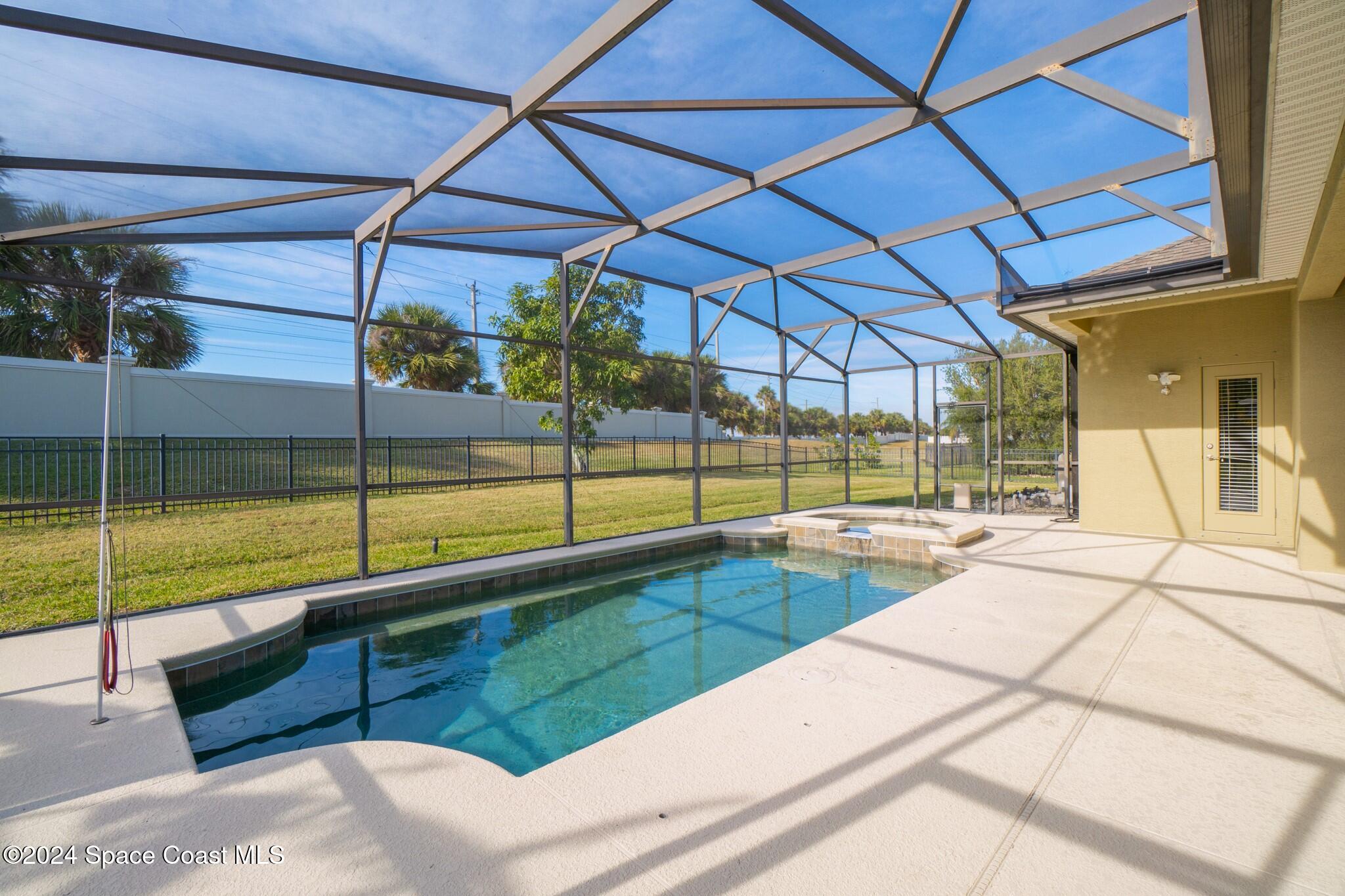 a view of a backyard with a swimming pool