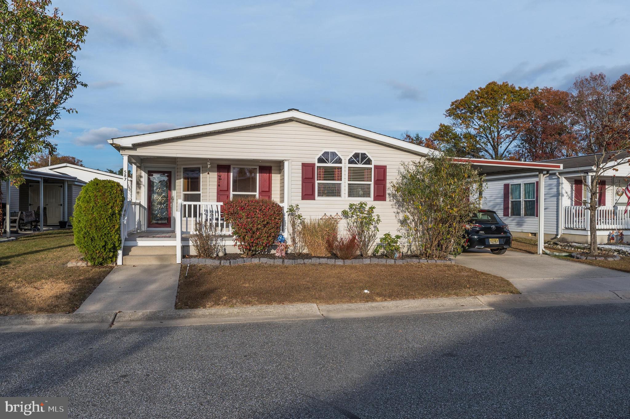 a front view of a house with a garden and plants