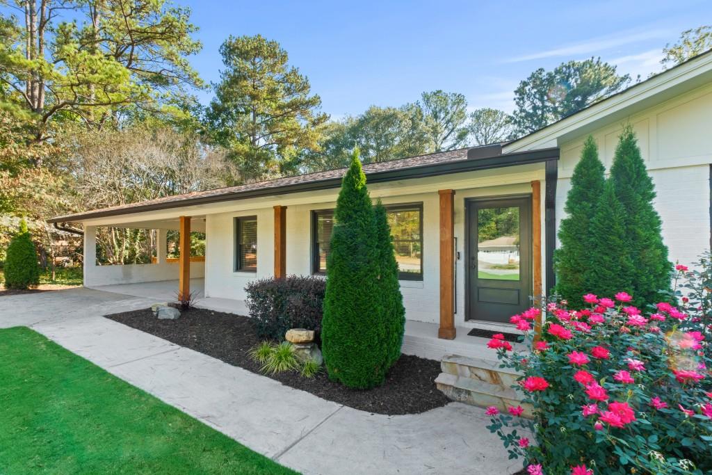 a front view of a house with plants