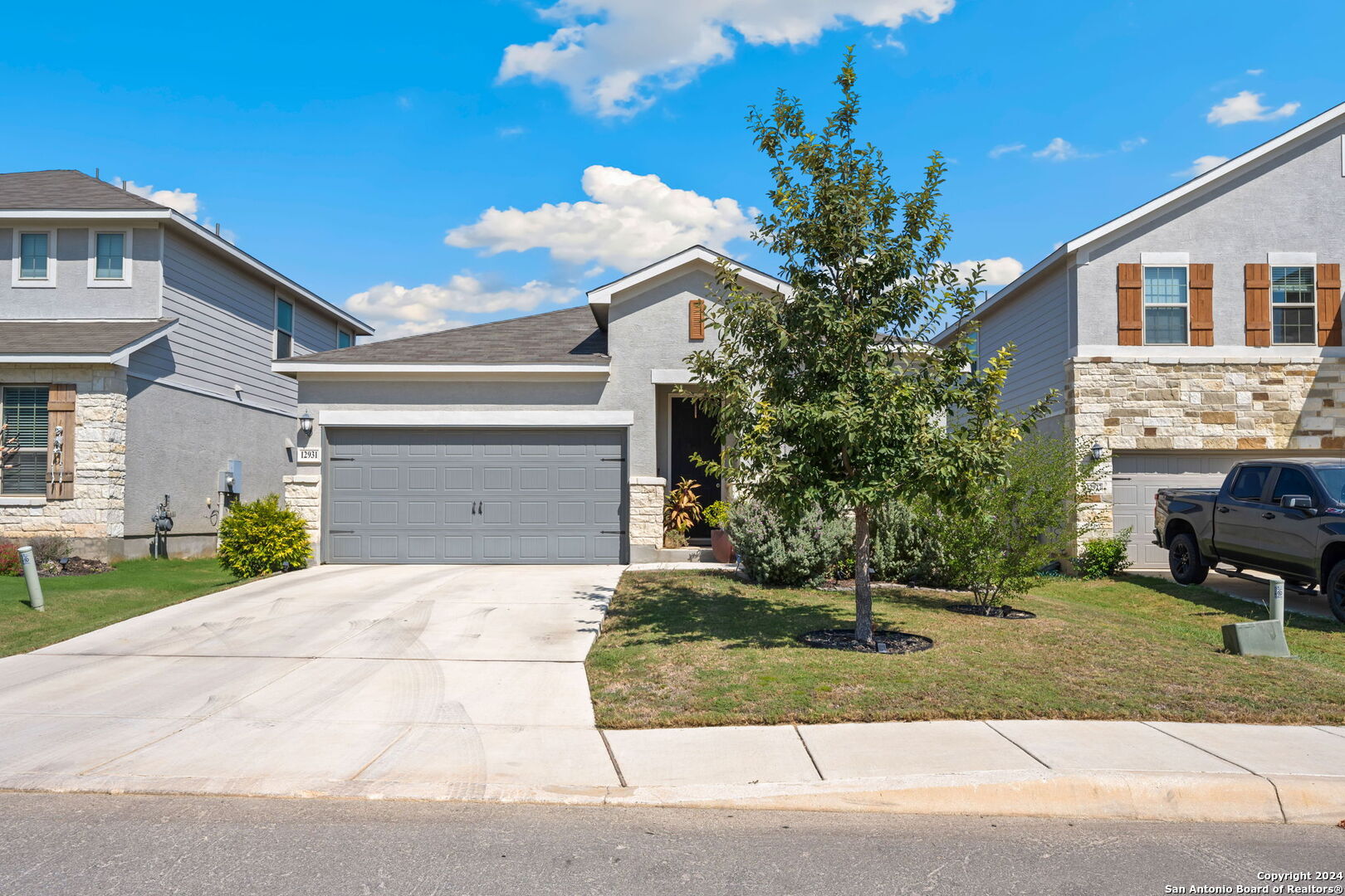 a front view of a house with a yard and garage