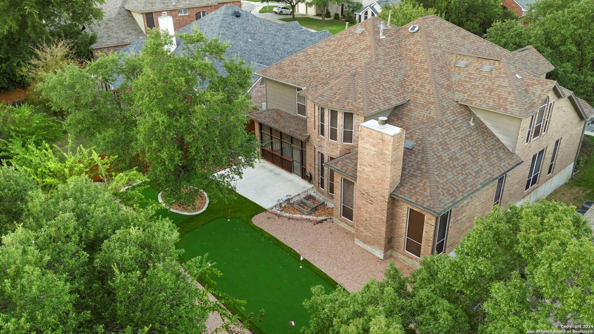 an aerial view of a house with garden space and street view