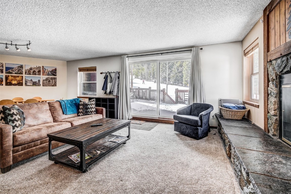 a living room with furniture and a floor to ceiling window