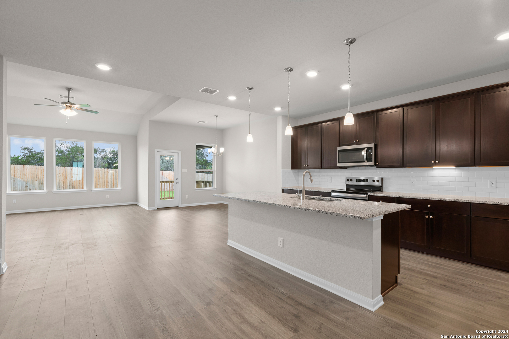 a large kitchen with stainless steel appliances lots of counter top space