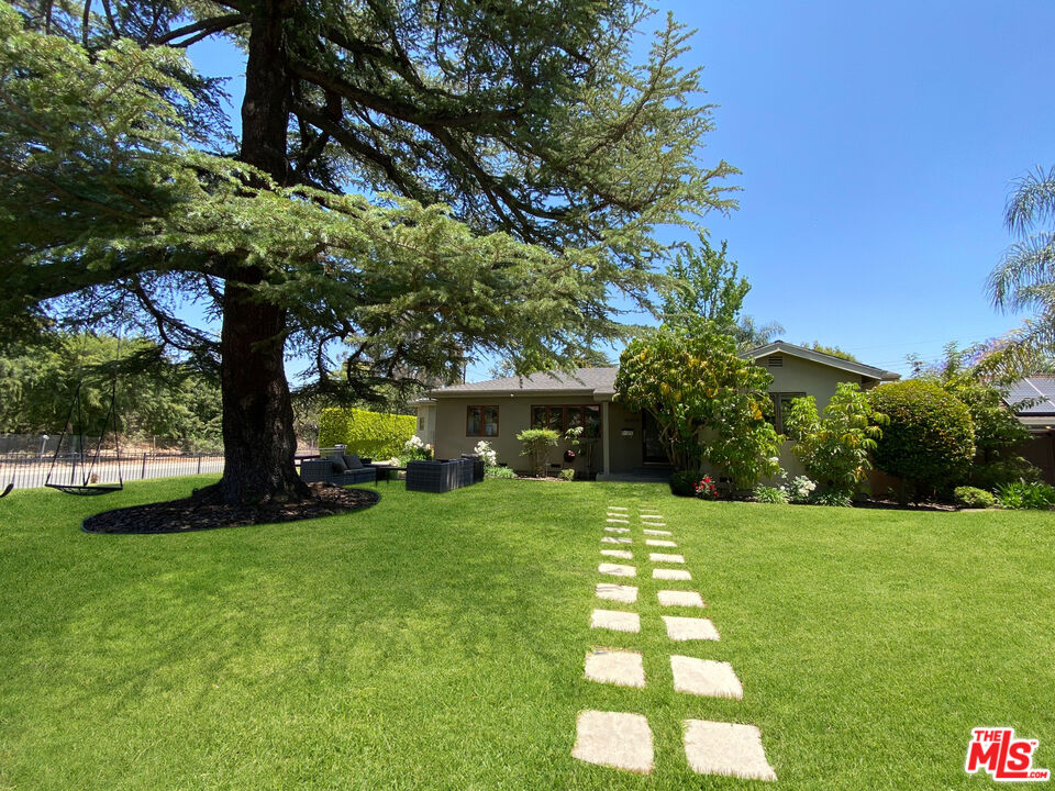 a view of a backyard with large trees