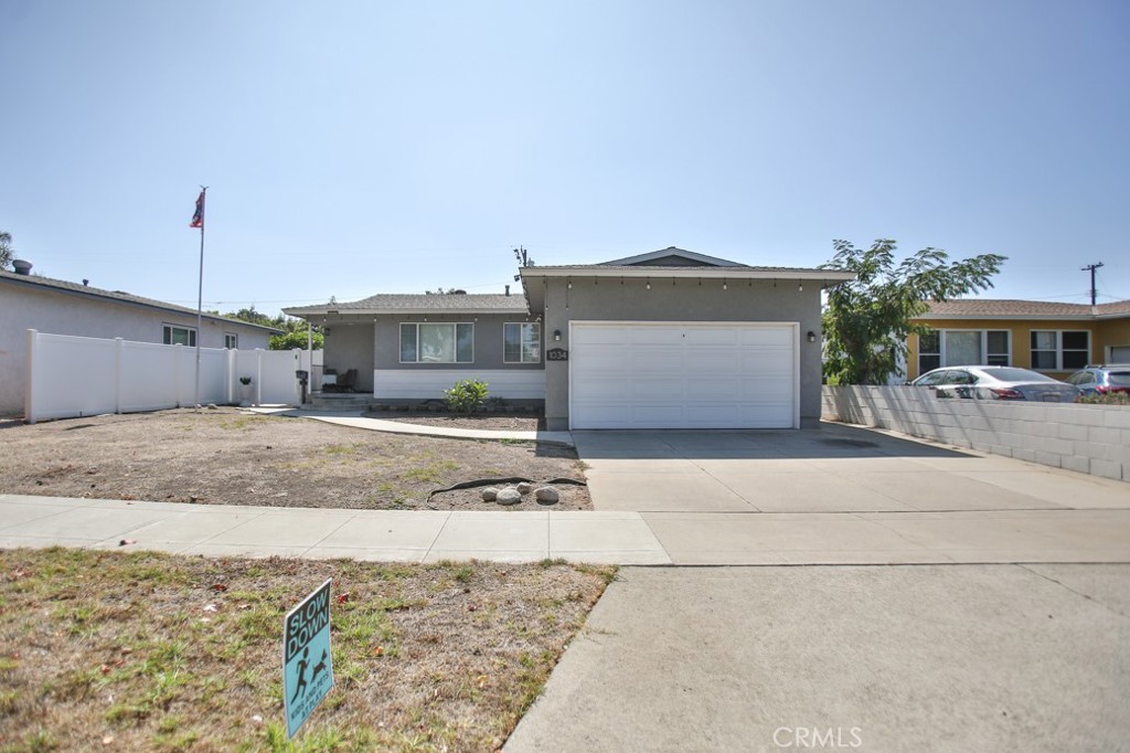 a view of a house with a backyard and a garage