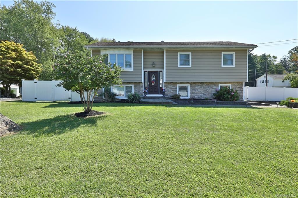 Raised ranch with a front yard