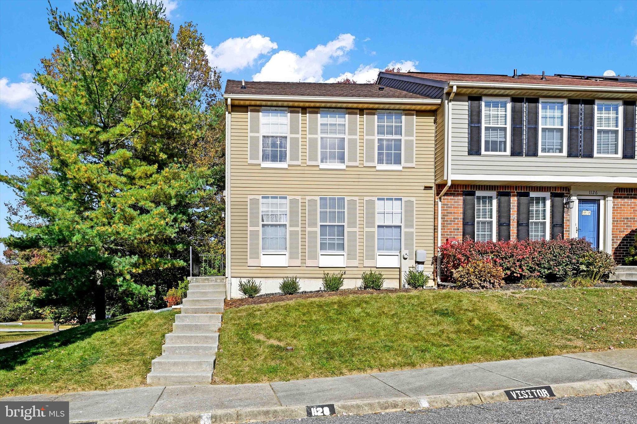 front view of a brick house with a yard