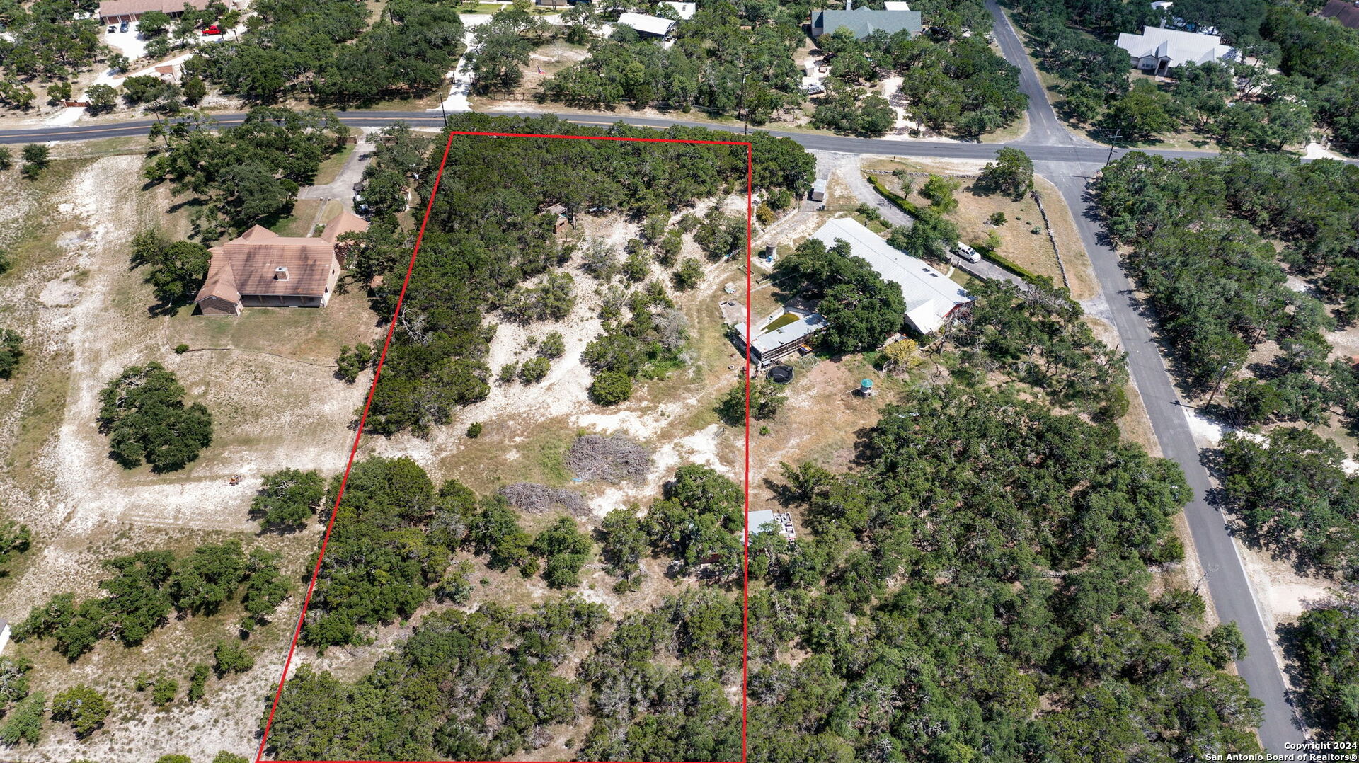 an aerial view of lake residential houses with outdoor space and trees